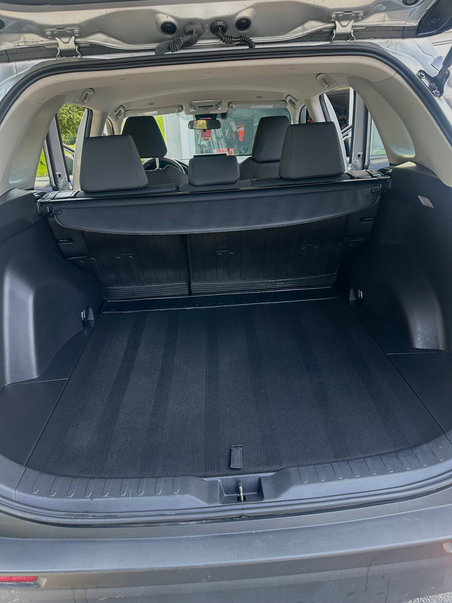 Subaru Forester rear cargo area after full vacuum with fresh carpet stripes
