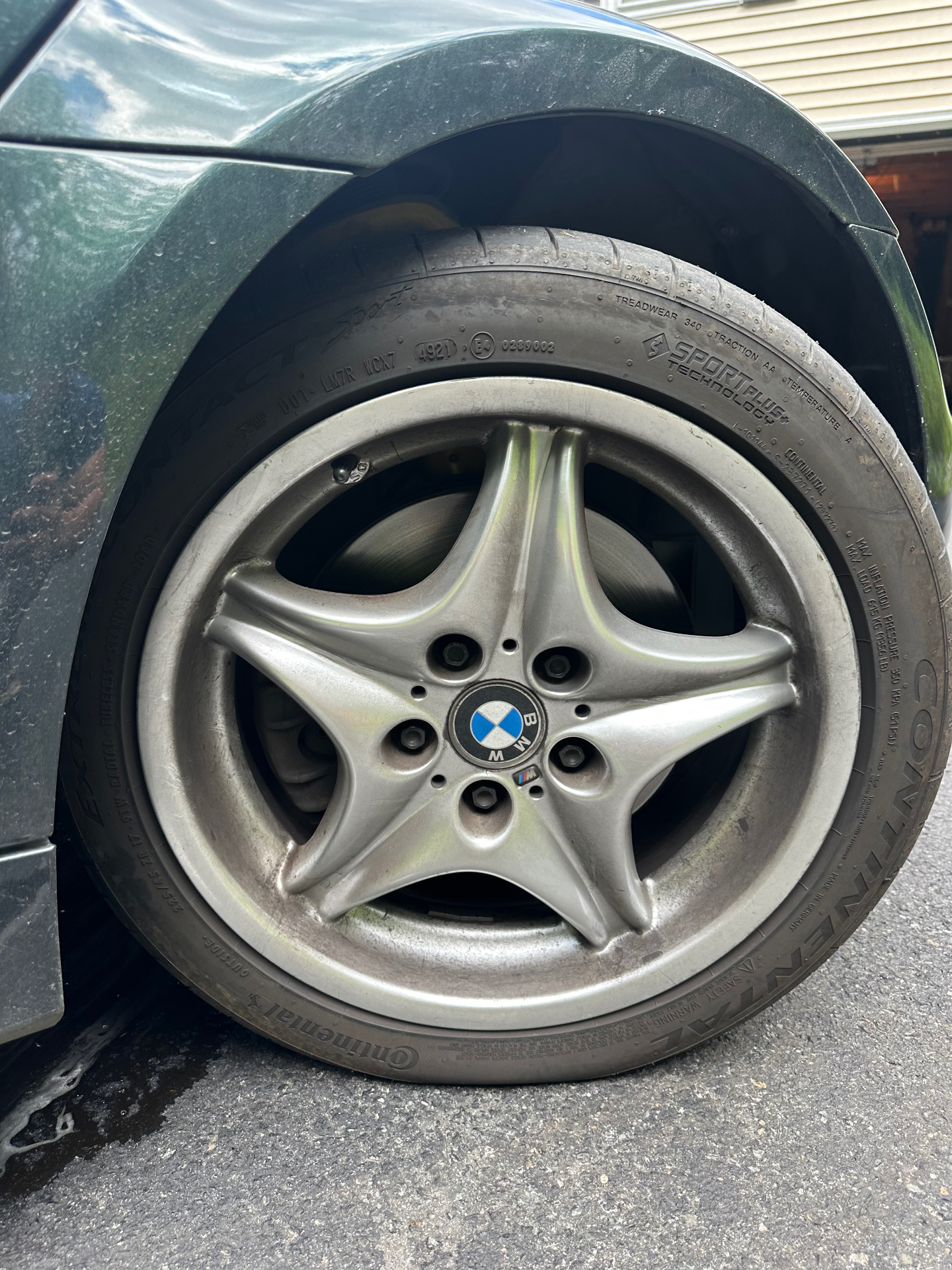 BMW Z3 wheel and tire before and after cleaning and tire dressing — before
