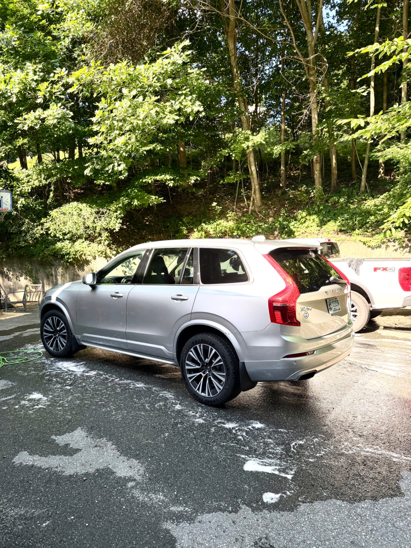 Silver Volvo XC90 rear three-quarter mid foam wash