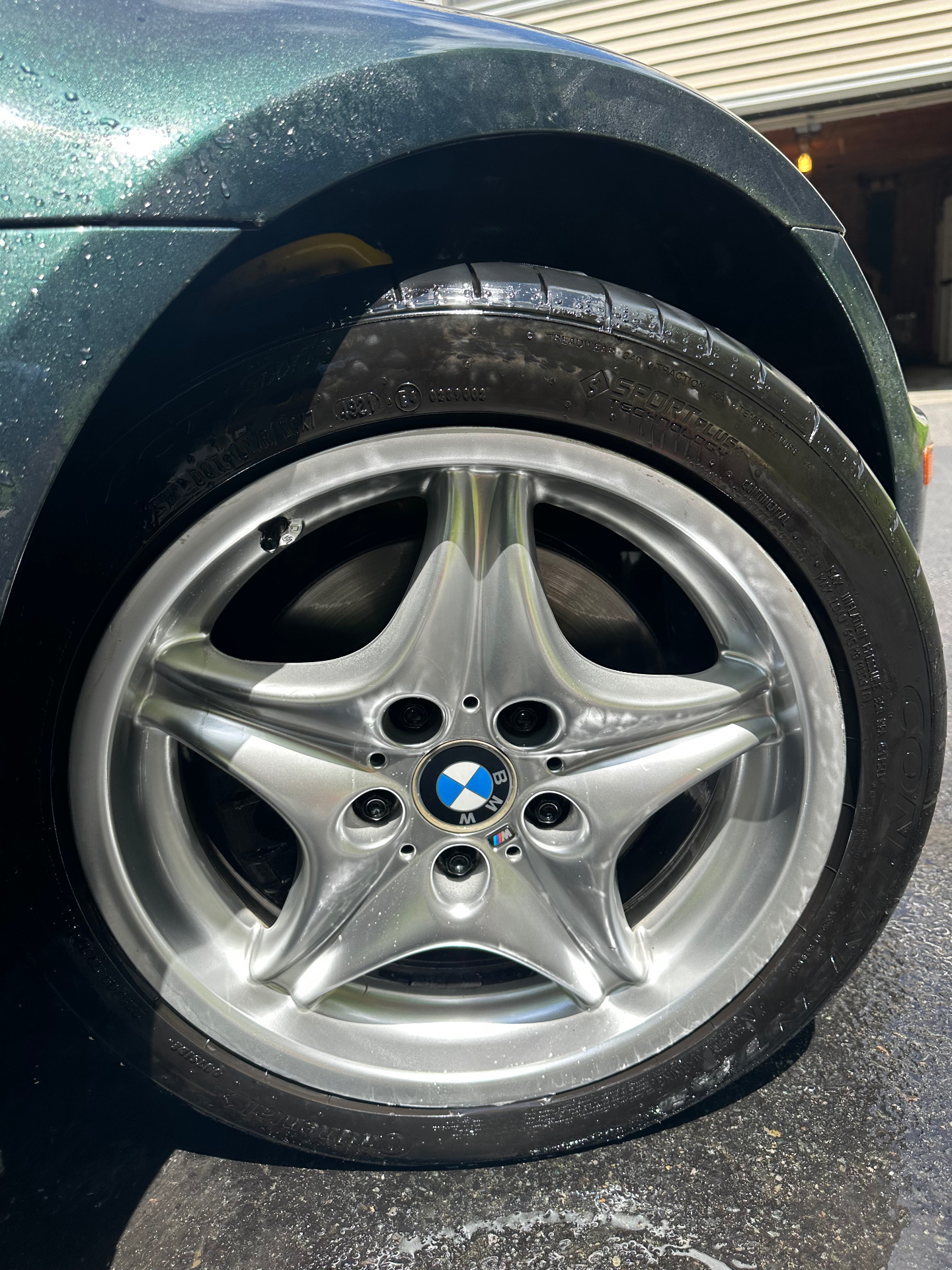 BMW Z3 wheel and tire before and after cleaning and tire dressing — after
