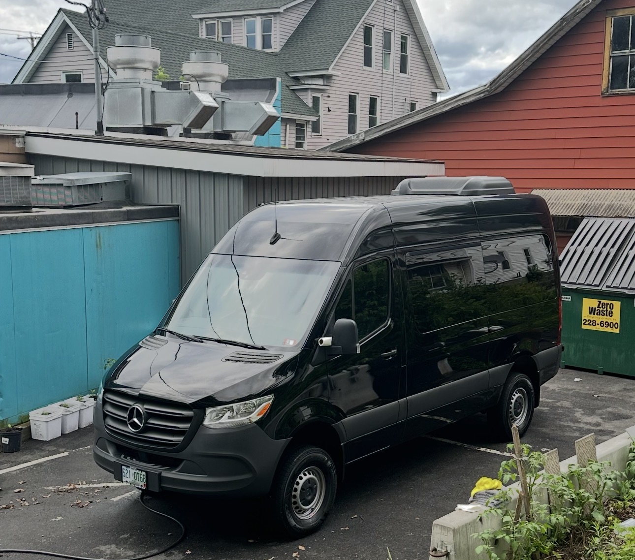 Black Mercedes Sprinter front three-quarter after exterior detail